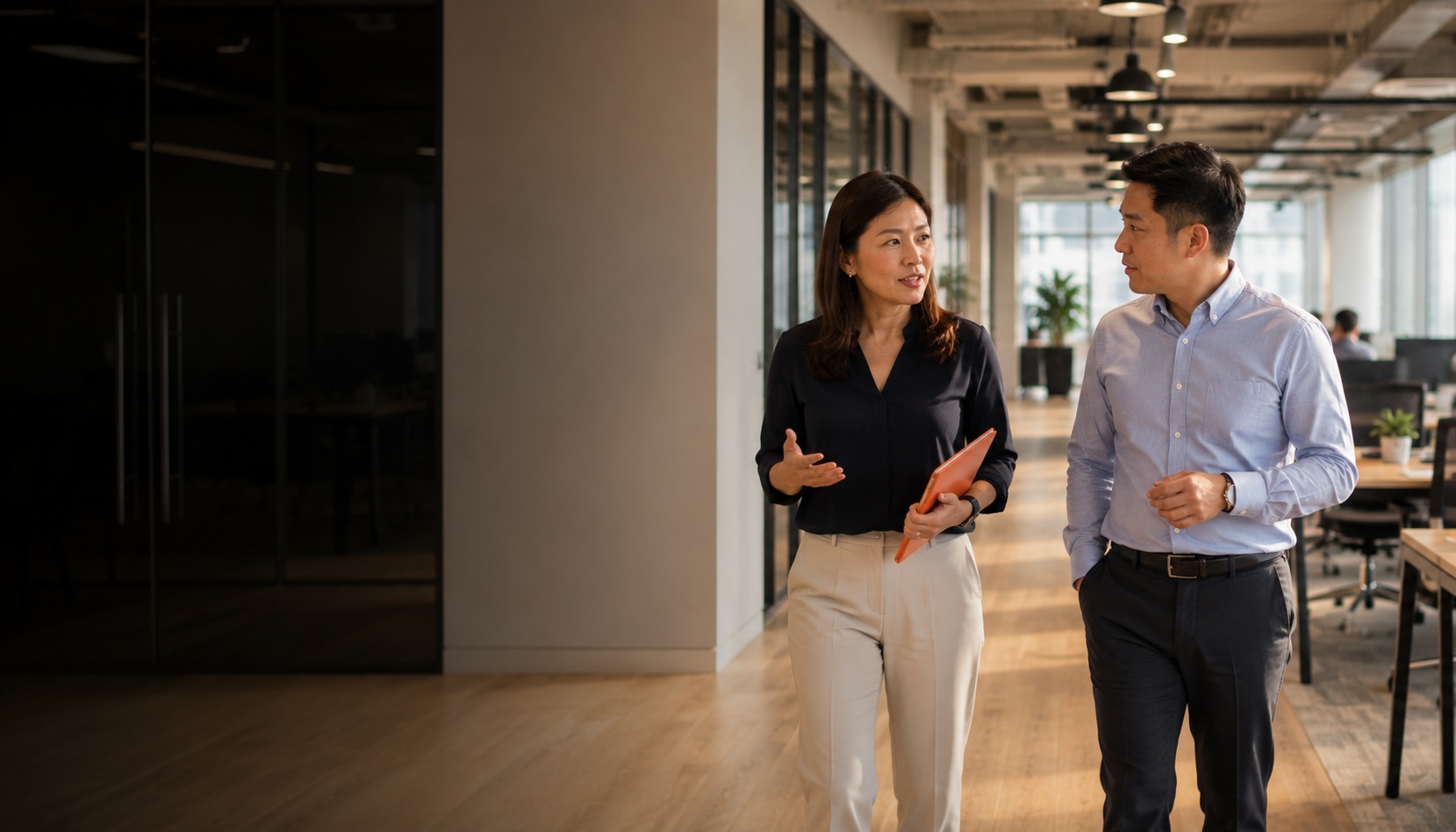 HR Shared Services Indonesia - People Profilers HR consultant walking with client through a Thailand office, mid-conversation about HR services